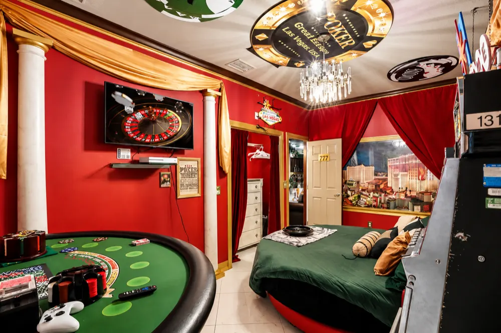 The Casino Games Suite: the blackjack table with chips and cards, the roulette wheel on the TV, the round bed and the Las Vegas skyline window