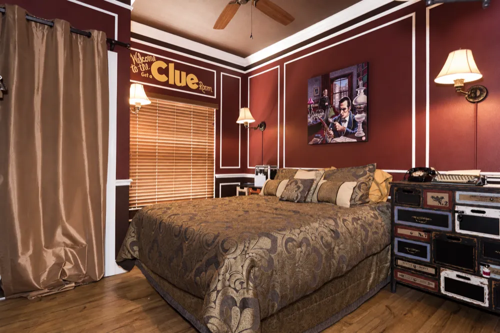 The Get A Clue bedroom by daylight: the damask bed, the detective painting and the numbered-drawer chest