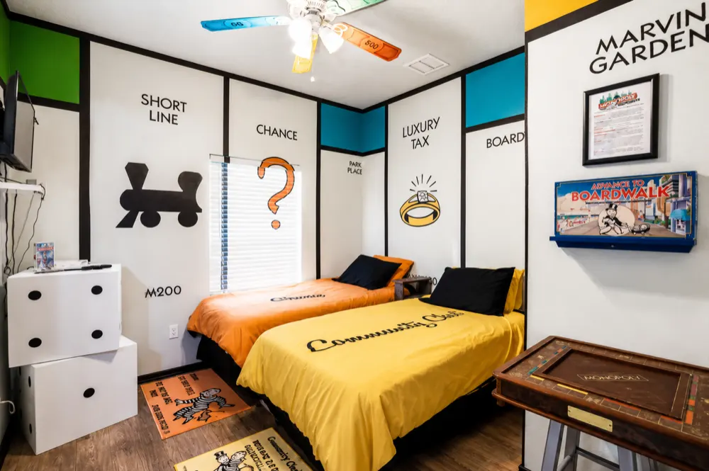 Monopoly themed bedroom with twin beds styled as Chance and Community Chest cards at Great Escape Lakeside Orlando vacation rental
