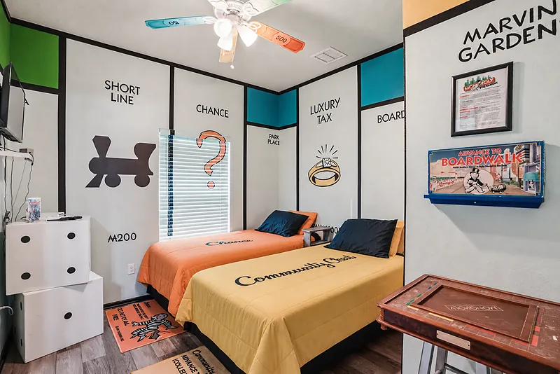 Monopoly themed bedroom with two twin beds at Great Escape Lakeside Orlando vacation rental