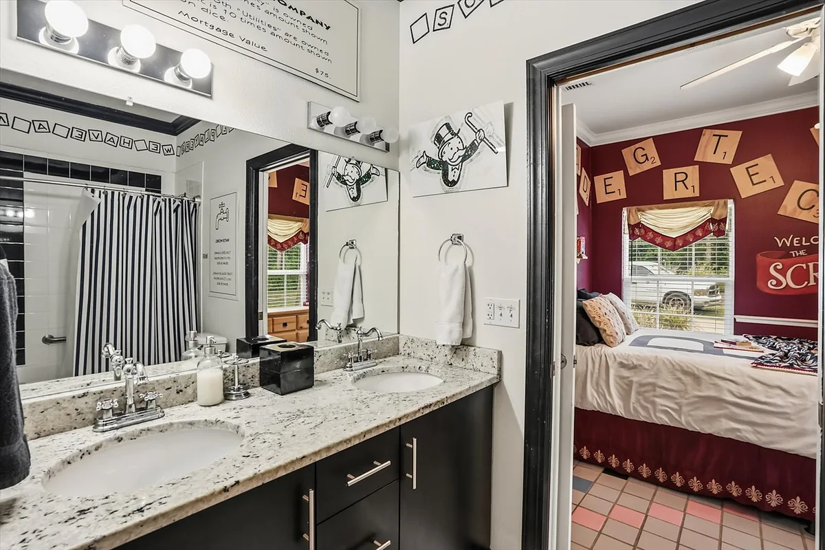 Jack-n-Jill bathroom with double vanity and granite countertops shared between Scrabble and Monopoly themed bedrooms at Great Escape Lakeside Orlando vacation rental