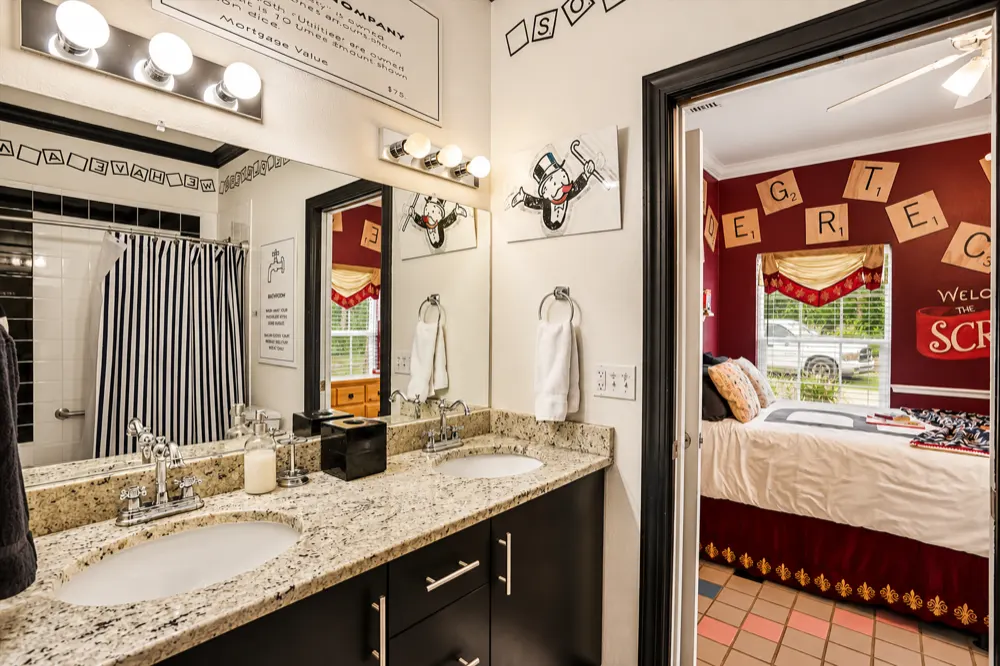 Jack-n-Jill bathroom with double granite vanity shared between the Scrabble and Monopoly themed bedrooms at Great Escape Lakeside