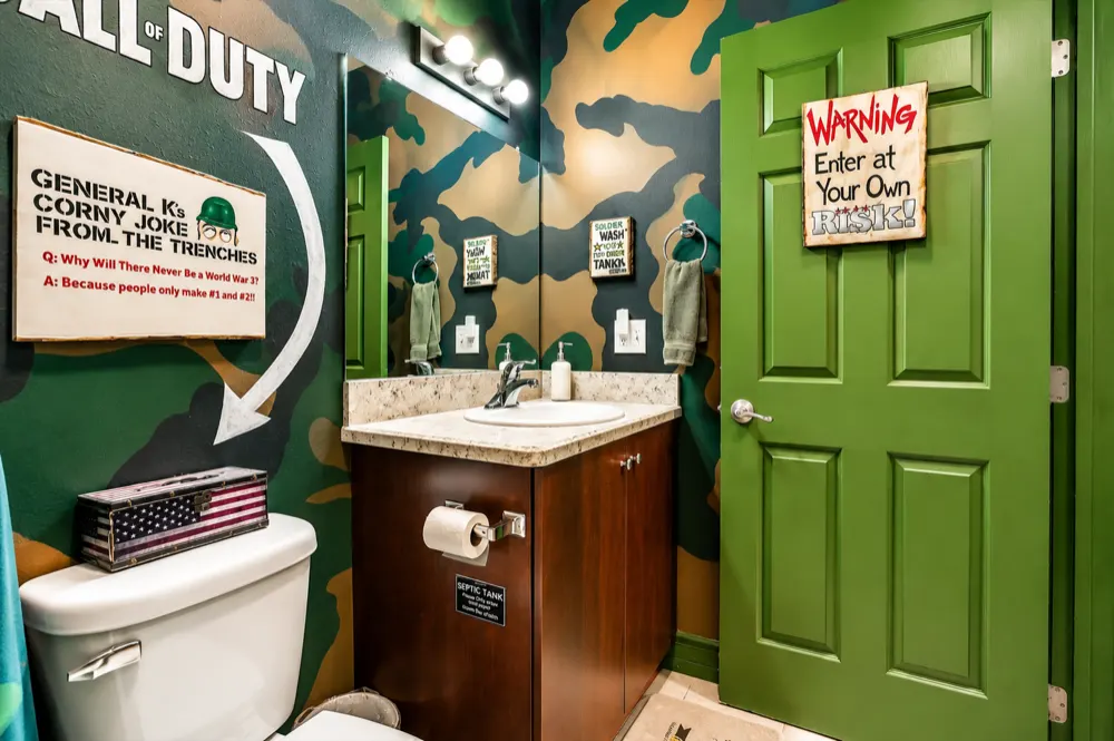 The Battleship bath: camo walls, Call of Duty lettering, General K's corny joke from the trenches, a granite vanity and the green door